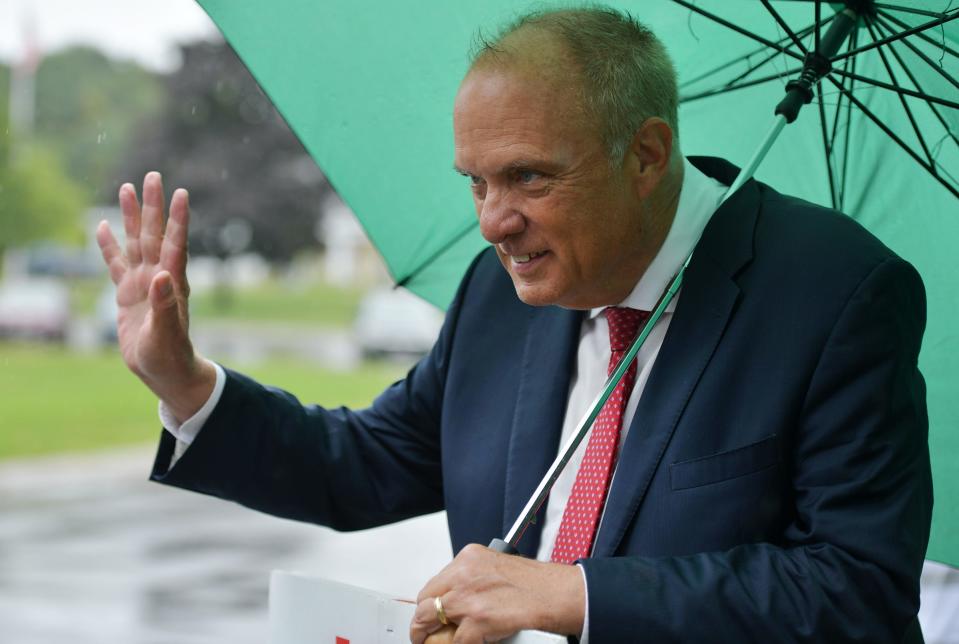 Mayor Joseph M. Petty waves to a voter as they arrive at the Senior Center Tuesday.