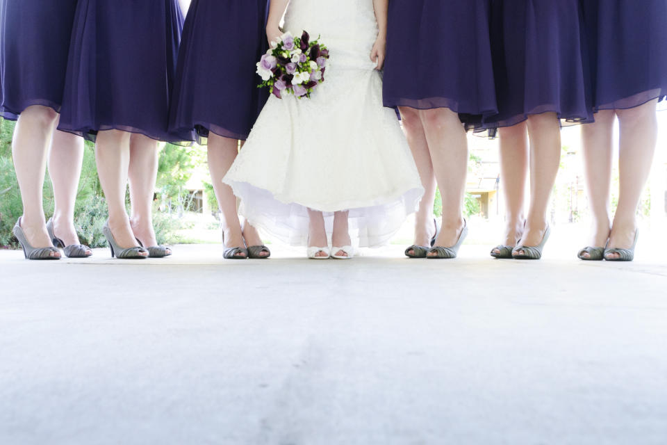 Six bridesmaid and bride standing.