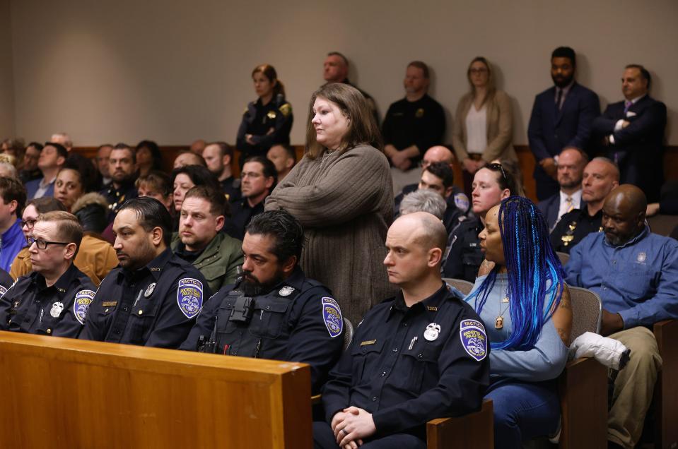 Lynn Mazurkiewicz stands among family and police officers as Kelvin Vickers is led out of the courtroom after receiving a sentence of life in prison without the possibility of parole. Vickers was convicted of killing Lynn’s husband, Anthony Mazurkiewicz and two other men.