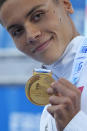 First placed Romania's David Popovici celebrates on the podium at the end of the men's 100m freestyle final at the European swimming championships, in Rome, Saturday, Aug. 13, 2022. (AP Photo/Andrew Medichini)