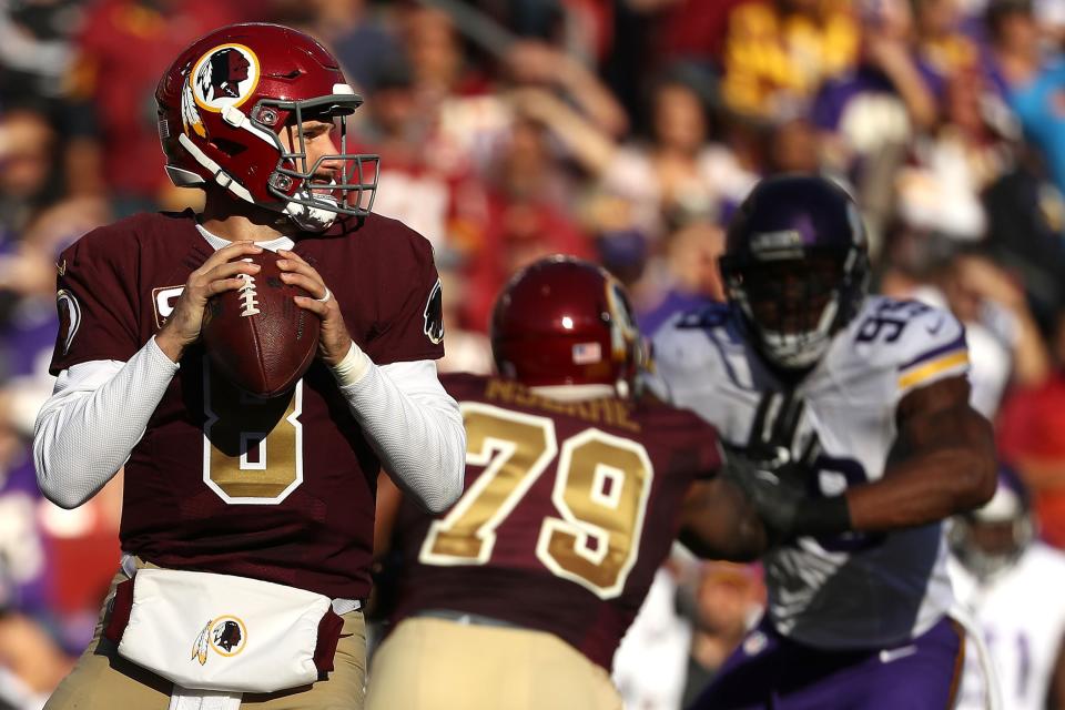 LANDOVER, MD - NOVEMBER 13: Quarterback Kirk Cousins #8 of the Washington Redskins looks to pass while teammate tackle Ty Nsekhe #79 blocks against defensive end Danielle Hunter #99 of the Minnesota Vikings in the second quarter at FedExField on November 13, 2016 in Landover, Maryland. (Photo by Patrick Smith/Getty Images)