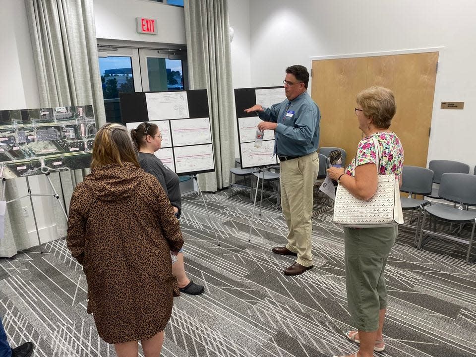 Scott Passmore, assistant program manager of the Corradino Group, middle right, meets with residents during a public meeting Tuesday about an upcoming project to redevelop Alf Coleman Road.
