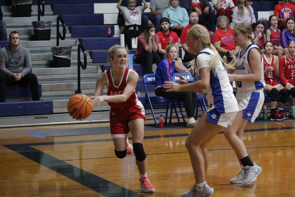 Pace's Alyssa Clark (12) attempts to keep the ball inbounds during the Patriots' 45-32 loss to Pace on Thursday, Dec. 14, 2023, in Jay.
