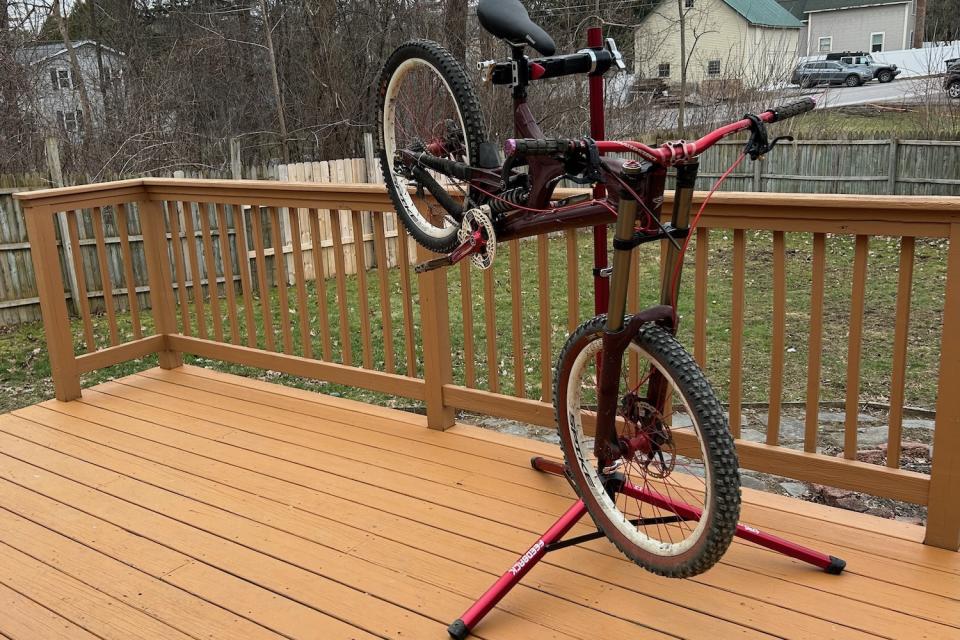 A heavy downhill bike held in the Feedback Sports Pro Mechanic bike work stand