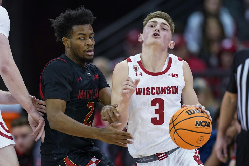 Wisconsin's Connor Essegian (3) drives against Maryland's Jahari Long (2) during the first half of an NCAA college basketball game Tuesday, Dec. 6, 2022, in Madison, Wis. (AP Photo/Andy Manis)