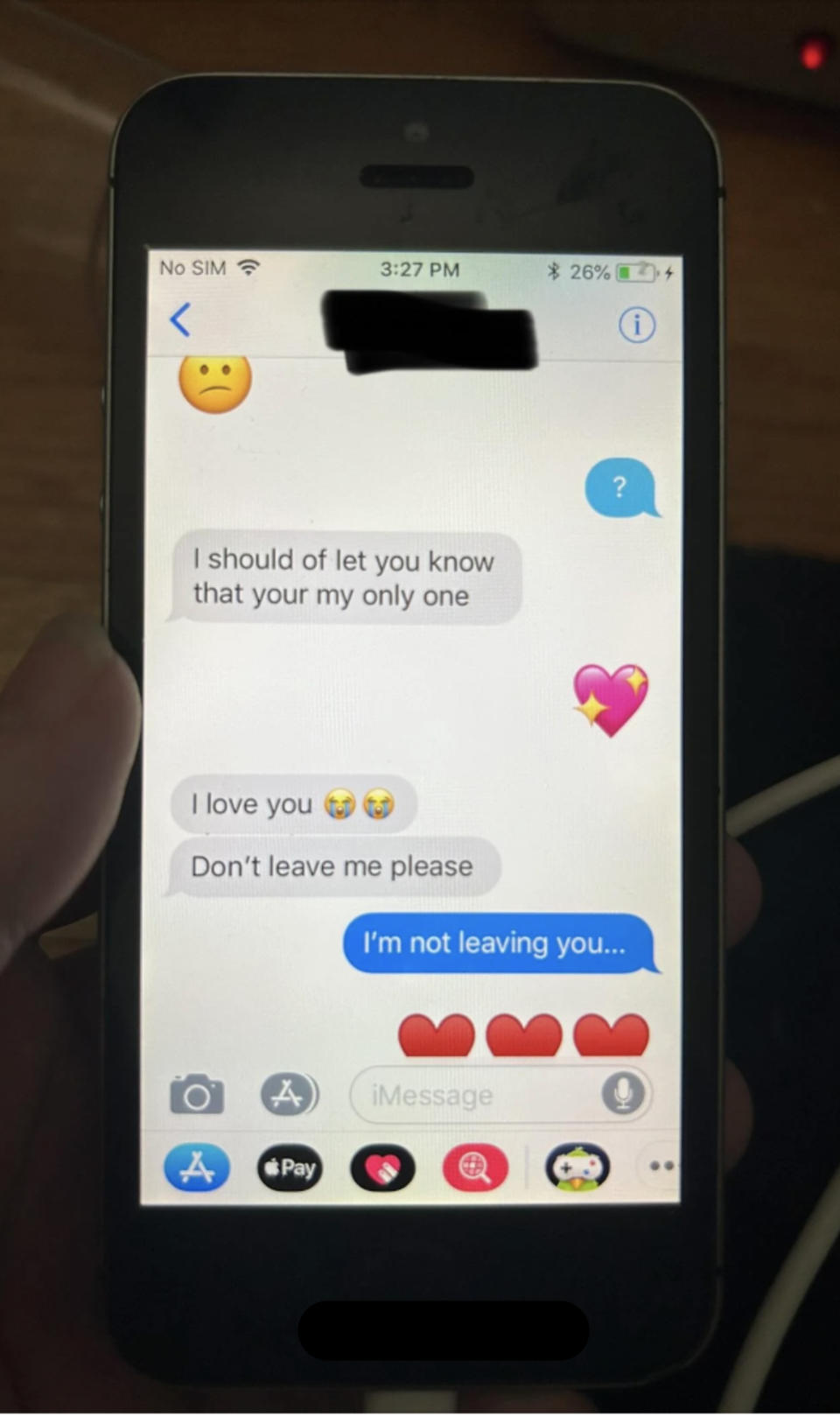 A smartphone displaying a conversation. Messages include an apology for not informing earlier, expressing love, asking not to leave, and reassurance of not leaving