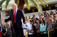 FILE PHOTO: Trump employees stand behind him in support at a campaign event at his Trump National Doral golf club in Miami, Florida