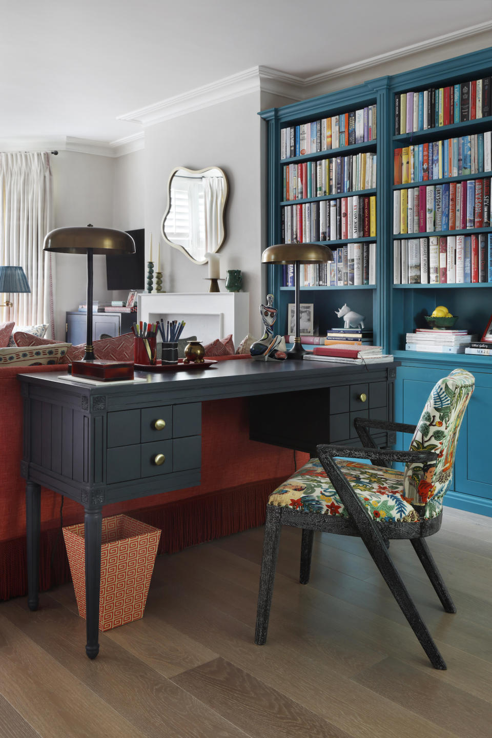 Living room with desk and built in storage painted blue