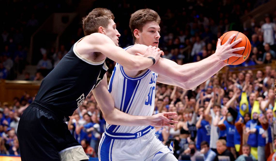 Duke’s Kyle Filipowski (30) drives by Wake Forest’s Andrew Carr (11) during the first half of Duke’s game against Wake Forest at Cameron Indoor Stadium in Durham, N.C., Tuesday, Jan. 31, 2023.