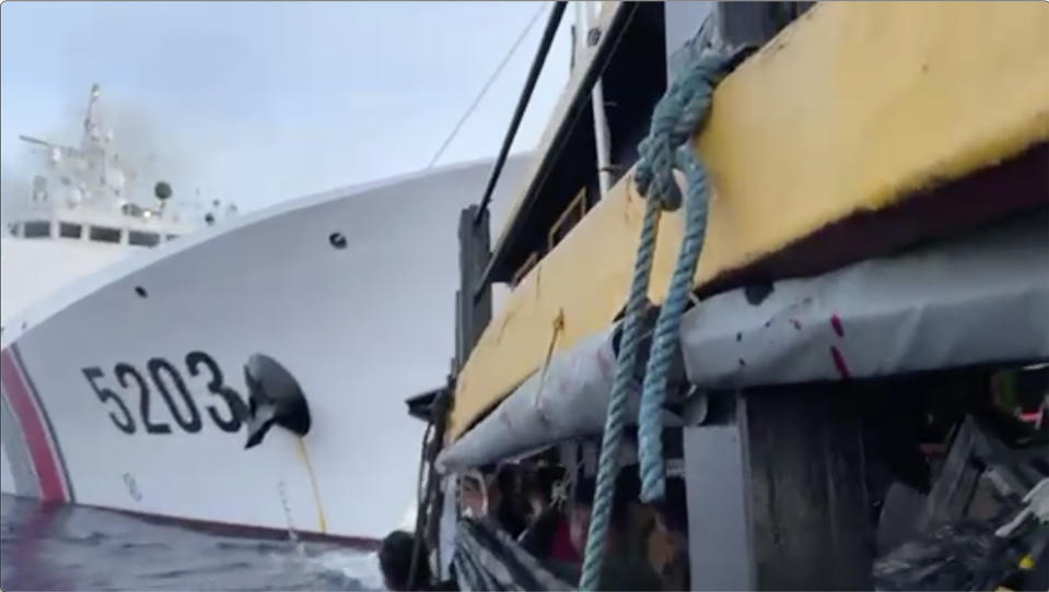 In this image from a video released by the Armed Forces of the Philippines, Filipino sailors, bottom, look after a Chinese coast guard ship with bow number 5203 bumps their supply boat as they approach Second Thomas Shoal, locally called Ayungin Shoal, at the disputed South China Sea on Sunday Oct. 22, 2023. (Armed Forces of the Philippines via AP)