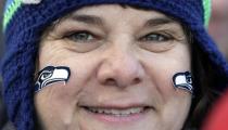 A Seattle Seahawks fan waits for the Super Bowl champions parade to begin Wednesday, Feb. 5, 2014, in Seattle. The Seahawks beat the Denver Broncos 43-8 in NFL football's Super Bowl XLVIII on Sunday.(AP Photo/Elaine Thompson)