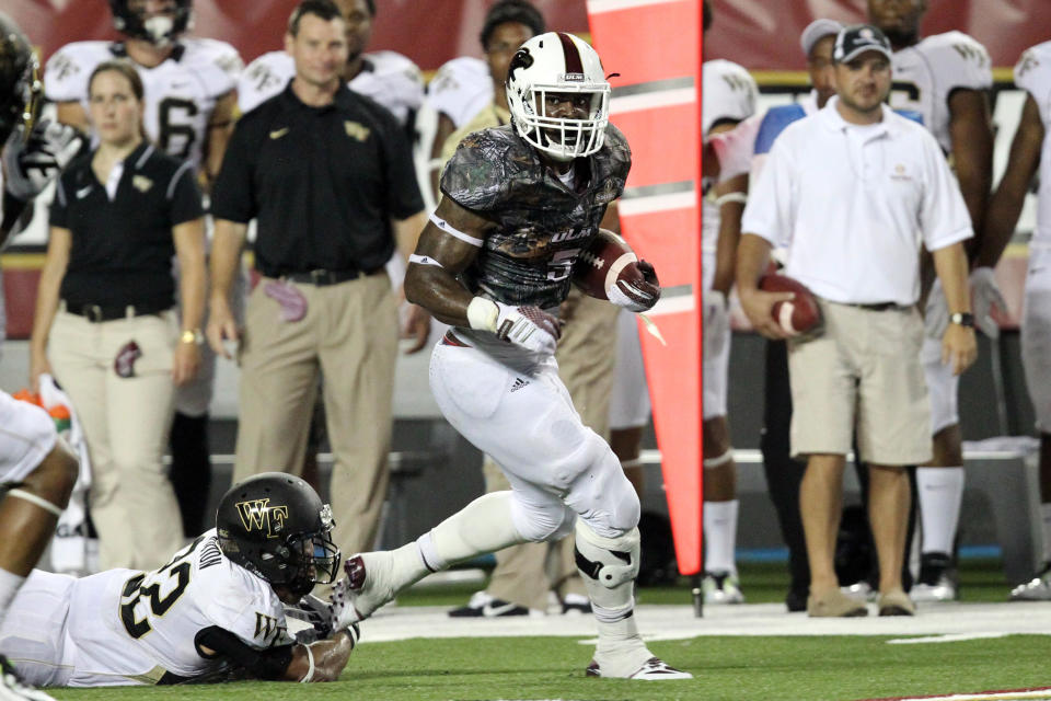 Aug 28, 2014; Monroe, LA, USA; Louisiana Monroe Warhawks running back Centarius Donald (5) rushes as Wake Forest Demon Deacons safety Ryan Janvion (22) attempts a tackle during the fourth quarter at Malone Stadium. Warhawks defeated the Demon Deacons 17-10. (Nelson Chenault-USA TODAY Sports)