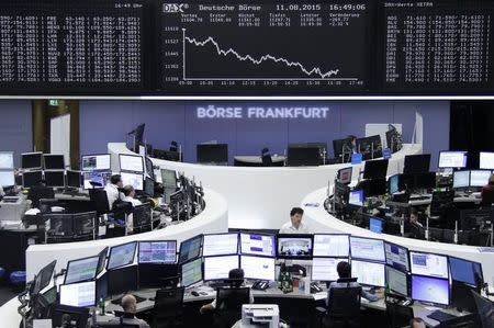 Traders are pictured at their desks in front of the DAX board at the stock exchange in Frankfurt, Germany August 11, 2015. REUTERS/Remote/Pawel Kopczynski