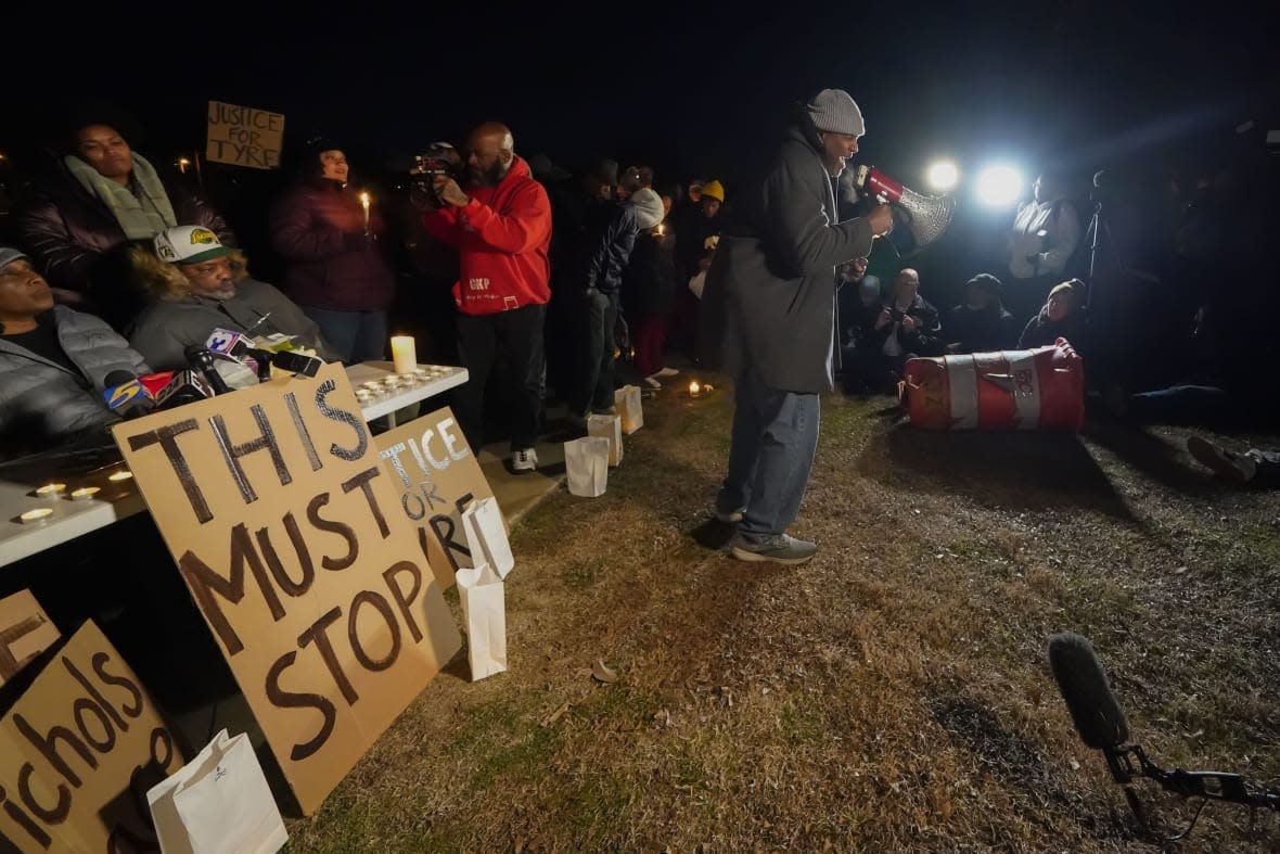 Rev. Andre E Johnson, of the Gifts of Life Ministries, preaches at a candlelight vigil for Tyre Nichols, who died after being beaten by Memphis police officers, in Memphis, Tenn., Thursday, Jan. 26, 2023. Behind him, seated at left, is Tyre’s stepfather Rodney Wells. (AP Photo/Gerald Herbert)