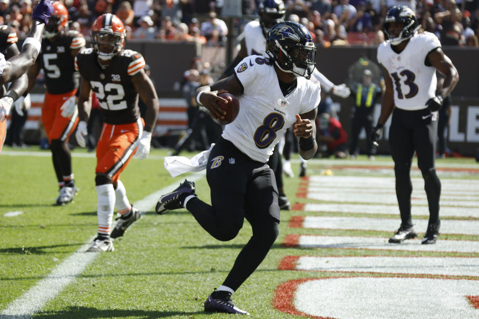 CORRECTS BYLINE TO RON SCHWANE NOT SUE OGROCKI - Baltimore Ravens quarterback Lamar Jackson (8) scores a 2-yard rushing touchdown during the first half of an NFL football game against the Cleveland Browns, Sunday, Oct. 1, 2023, in Cleveland. (AP Photo/Ron Schwane)