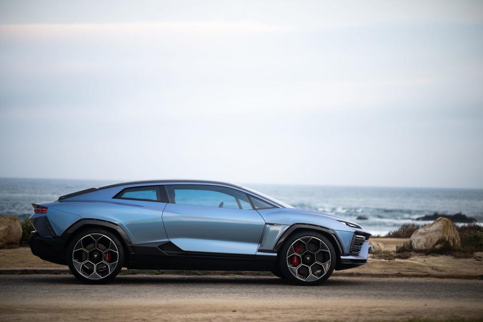 The Lamborghini Lanzador, seen in profile, with a beach and ocean in the background. 