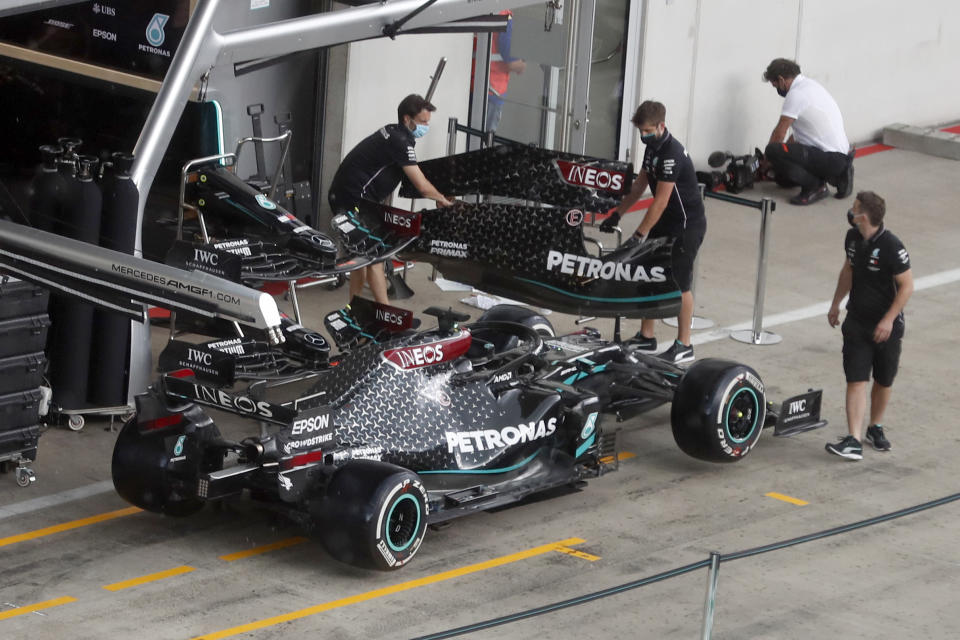 Mercedes technicians work around Lewis Hamilton's car the at the Red Bull Ring racetrack in Spielberg in Spielberg, Austria, Thursday, July 2, 2020. Austrian Formula One Grand Prix will be held on Sunday. (AP Photo/Darko Bandic)