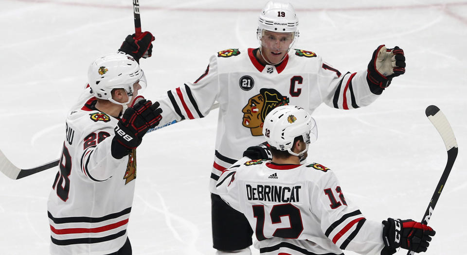 Jonathan Toews and Alex DeBrincat have made beautiful music together this season. (Jim Mone/AP)