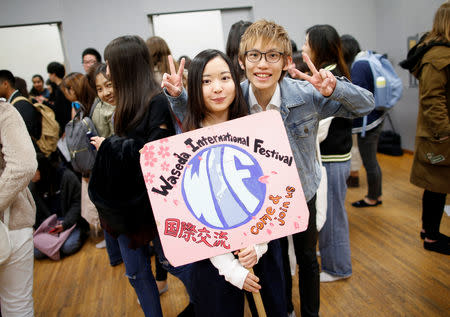 Yuri Harada (19), a student at Waseda University, poses for a photograph wth her friend during club activities at her university in Tokyo, Japan April 9, 2019. REUTERS/Issei Kato