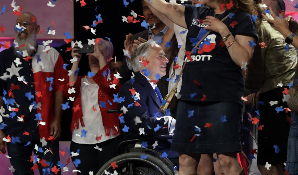 File - In this June 15, 2018 file photo, Confetti falls as Texas Gov. Greg Abbott, center, greets supporters after speaking at the Texas GOP Convention, in San Antonio. As the Texas GOP presses ahead with plans for a July convention amid a worsening coronavirus outbreak, the state's largest medical group Tuesday June 30, 2020, urged the party to reconsider before thousands of Republican activists flock to Houston, which has become one of the nation's most troubling hotspots. (AP Photo/Eric Gay File)