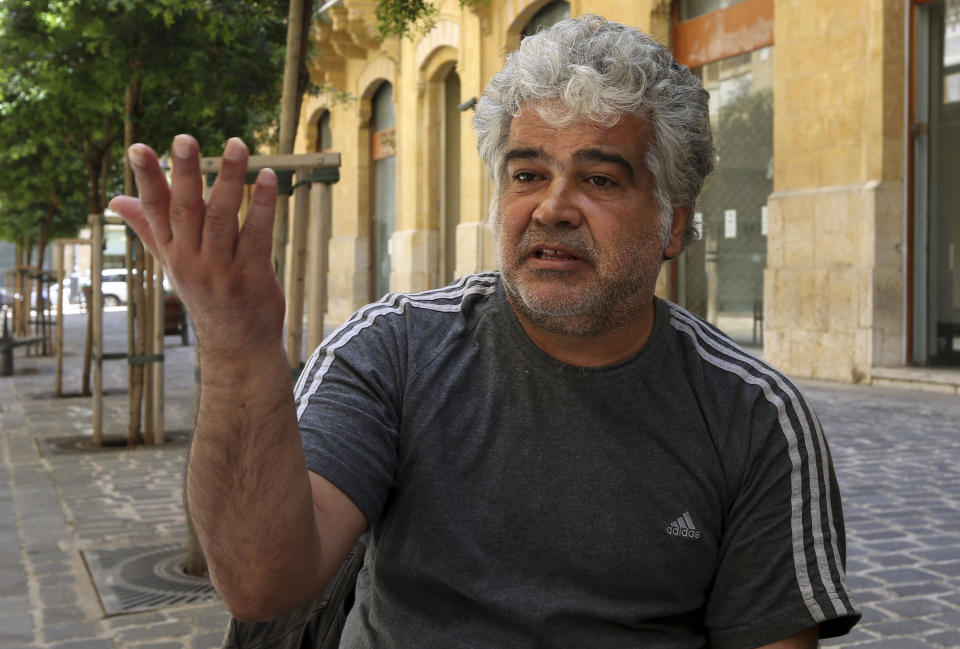 In this Monday, April 21, 2014 photo, Syrian novelist Khaled Khalifa, speaks during an interview with The Associated Press at a cafe in downtown Beirut, Lebanon. Khalifa’s thoughts keep wandering back to his home and favorite place in the world, the northern city of Aleppo, Syria. For him, the ancient metropolis is much more than a beautiful city known for its majestic, 13th century citadel, spicy cuisine and maze-like covered bazaar. It is his inspiration, the center of his pain, the place where the seeds of rebellion against an oppressive government were formed. (AP Photo/Bilal Hussein)