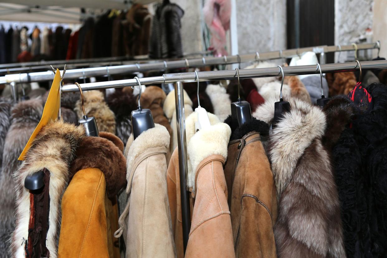 winter jackets fur coat hanging and second-hand clothes for sale