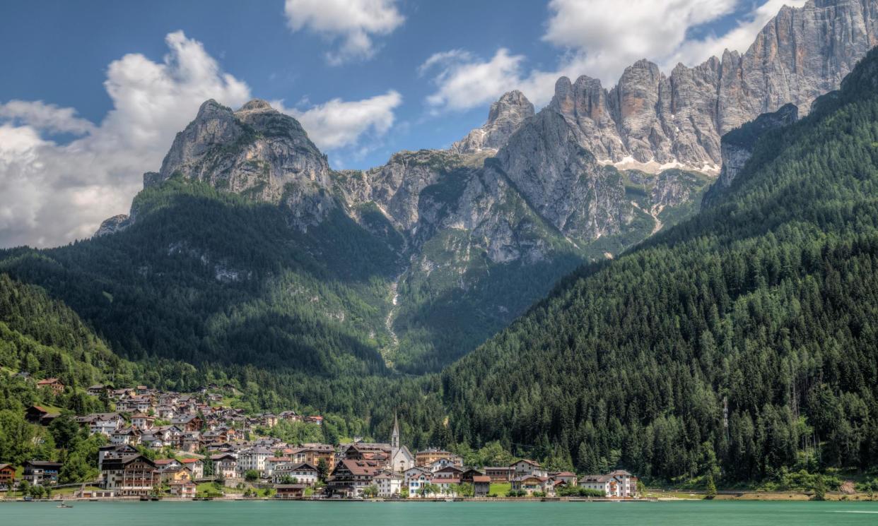 <span>Alleghe sits beneath the Civetta Group of eastern Dolomites mountains in northern Italy.</span><span>Photograph: Joana Kruse/Alamy</span>