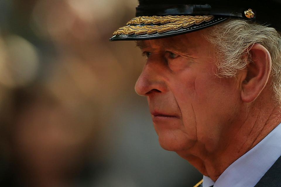 Britain's King Charles III walks behind the coffin of Queen Elizabeth II, adorned with a Royal Standard and the Imperial State Crown, pulled by a Gun Carriage of The King's Troop Royal Horse Artillery, during a ceremonial procession of the coffin of Queen Elizabeth II, from Buckingham Palace to Westminster Hall. Wednesday Sept. 14, 2022.