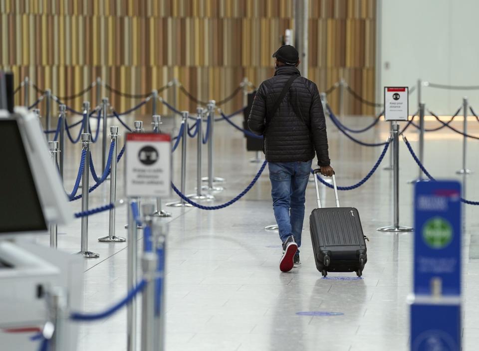 A traveller at Heathrow Airport (Steve Parsons/PA) (PA Wire)