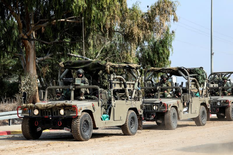 FILE PHOTO: Israeli soldiers drive in military vehicles by Israel's border with Gaza in southern Israel