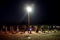 A group of migrants walks to catch a train after crossing the border from Greece to Macedonia at the village of Gevgelija on August 29, 2015