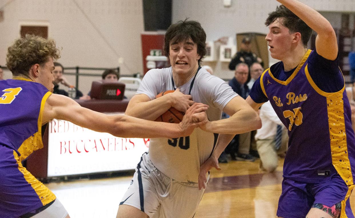 CBA's Peter Noble drives between a pair of St. Rose defenders in a Shore Conference Tournament semifinal in Little Silver, N.J. on Feb. 14, 2024.