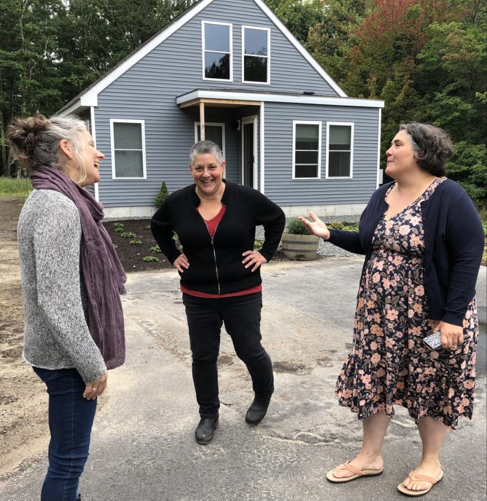 Larissa Crockett, right, the executive director of the Kennebunkport Heritage Housing Trust, enjoys a light moment with Jennifer Armstrong, left, and Tanya Alsberg at their new home on Briggs Way on Tuesday, Sept. 21, 2022. Armstrong and Alsberg purchased the home from the Trust at an affordable price earlier this year.