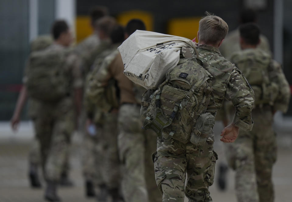 Members of the British armed forces 16 Air Assault Brigade walk to the air terminal after disembarking a RAF Voyager aircraft at Brize Norton, England, as they return from helping in operations to evacuate people from Kabul airport in Afghanistan, Saturday, Aug. 28, 2021. More than 100,000 people have been safely evacuated through the Kabul airport, according to the U.S., but thousands more are struggling to leave in one of history's biggest airlifts. (AP Photo/Alastair Grant, Pool)