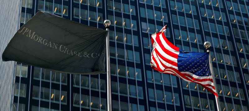 FILE PHOTO: The JP Morgan and U.S. flags wave outside the JP Morgan headquarters in New York