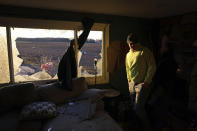 Patrick Crull tours the damage inside his home along North Tolles Road, Friday morning, Feb. 9, 2024, after a confirmed tornado went through the area just northwest of Evansville, Wis., the prior evening. The tornado was the first-ever reported in February in the state of Wisconsin, according to the National Weather Service. (Anthony Wahl//The Janesville Gazette via AP)