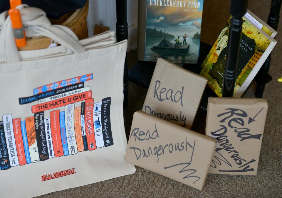 Staff at the Brewster Book Store and six other area shops have hidden books in outdoor community areas this week for their first Cape and Islands Banned Book Hunt. The wrapped-up books look like these displayed in the Brewster store and, if found, are yours to keep, share or donate.