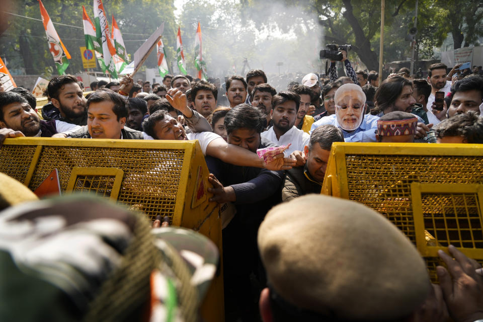 Members of opposition Congress party, demanding an investigation into allegations of fraud and stock manipulation by India's Adani Group try to break a police barricade during a protest in New Delhi, India, Monday, Feb.6, 2023. The Congress party urged people to protest, adding to pressure on Prime Minister Narendra Modi to respond to a massive sell-off of shares in Adani Group companies after a U.S.-based short-selling firm, Hindenburg Research, accused them of various fraudulent practices. The Adani group has denied any wrongdoing. (AP Photo/Manish Swarup)