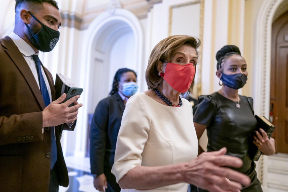 Speaker of the House Nancy Pelosi, D-Calif., center, walks with newly-elected Rep. Shontel Brown, D-Ohio, right, at the Capitol in Washington, Thursday, Nov. 4, 2021. Brown, 46, won the Cleveland-area House seat formerly held by Marcia Fudge, who left to become secretary of the Department of Housing and Urban Development in the Biden administration. (AP Photo/J. Scott Applewhite)