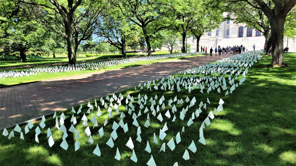 Thousands of white flags mark the State House lawn during Saturday's opening of a week-long remembrance of Rhode Islanders lost to COVID.