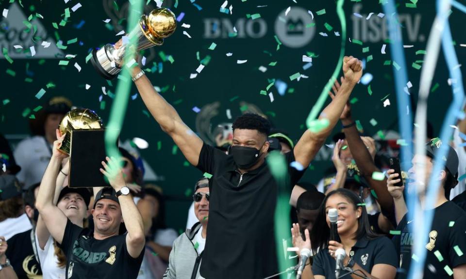 Giannis Antetokounmpo celebrates during a victory parade in the Deer District in Milwaukee.