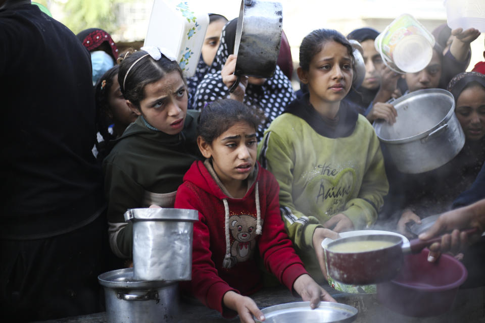 Palestinians line up for a free meal in Rafah, Gaza Strip, Wednesday, Dec. 20, 2023. (AP Photo/Hatem Ali)