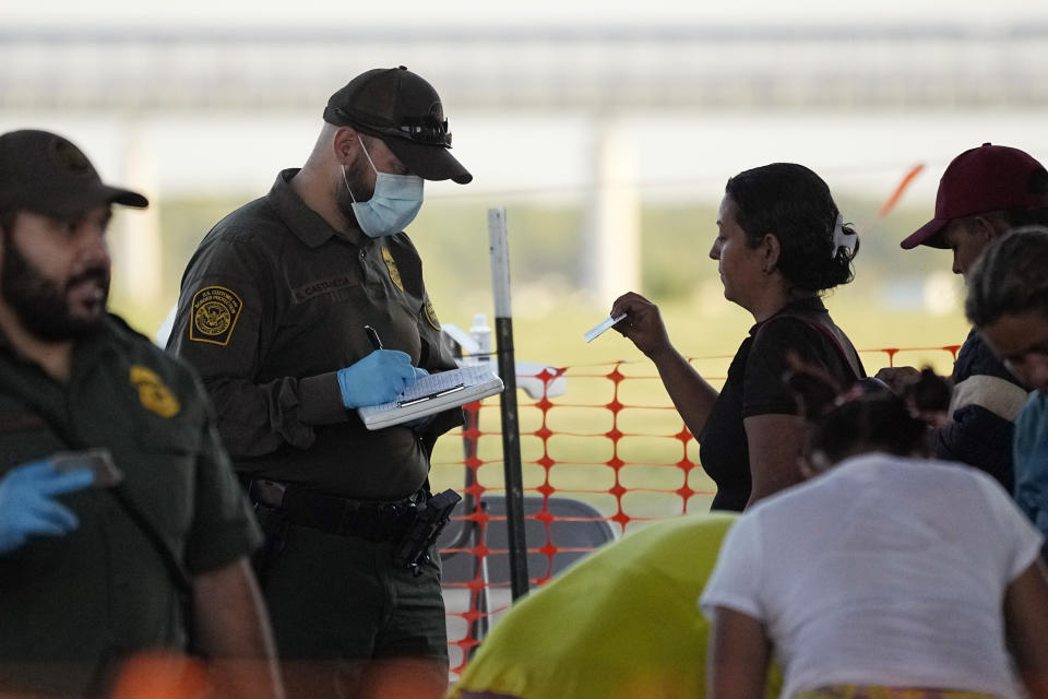 Migrants who crossed the Rio Grande and entered the U.S. from Mexico are lined up for processing by U.S. Customs and Border Protection, Saturday, Sept. 23, 2023, in Eagle Pass, Texas. (AP Photo/Eric Gay)