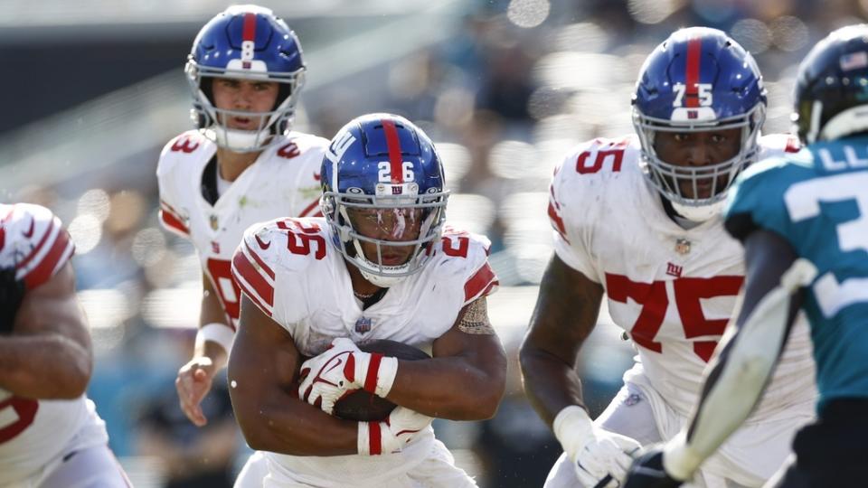 Oct 23, 2022; Jacksonville, Florida, USA; New York Giants running back Saquon Barkley (26) runs with the ball against the Jacksonville Jaguars during the fourth quarter at TIAA Bank Field.