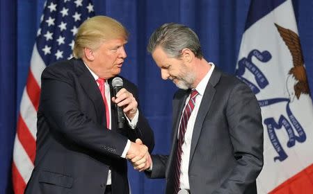 U.S. Republican presidential candidate Donald Trump (L) shakes hands with Jerry Falwell Jr. at a campaign rally in Council Bluffs, Iowa, January 31, 2016. REUTERS/Scott Morgan