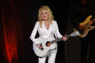 FILE - Dolly Parton performs in concert on July 31, 2015, in Nashville, Tenn. The Grammy-winning legend's 1980's hit "9 to 5" has been flipped by Squarespace, the company that helps users build and host their own websites, for a Super Bowl commercial debuting Tuesday, Feb. 2, 2021. Oscar winner Damien Chazelle of "La La Land" fame directed the spot. (Photo by Wade Payne/Invision/AP, File)