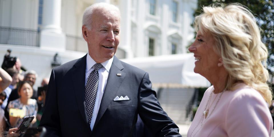 Joe and Jill Biden hold hands outside of the White House