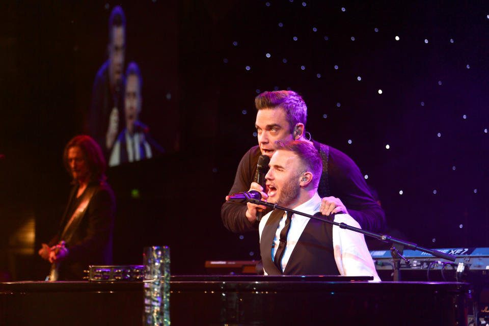 FILE - Robbie Williams, left, and Gary Barlow perform at the 2012 Music Industry Trusts Award ceremony at the Grosvenor House Hotel on Monday, Nov. 5, 2012, in London. (Photo by John Marshall JM Enternational/Invision/AP)