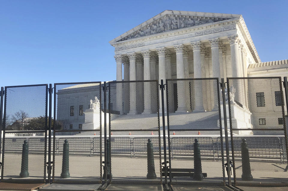 Anti-scaling fencing has been placed in front of the Supreme Court, which stands across the street from the U.S. Capitol, Sunday, Jan. 10, 2021, in Washington. (AP Photo/Alan Fram)