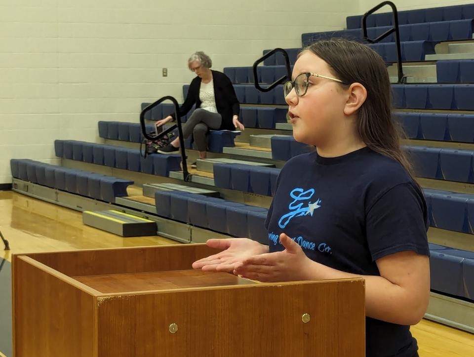 Aralyn Schwartz, a Woodmore fifth-grader, speaks to the school board in support of middle school Principal Kevin Ball.